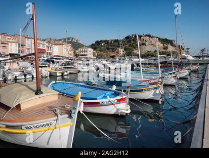 Boats docked in a quay of Cassis port town in France. Château de Cassis in the background. Cassis travel photography. Stock Photo