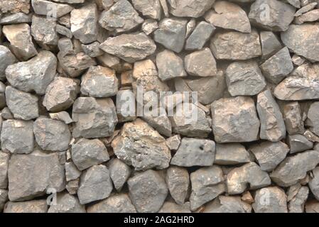 Rough natural drystone wall. Texture detail close up. Stock Photo