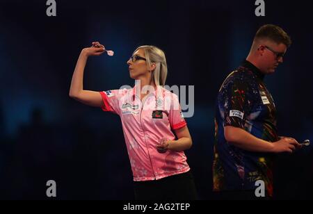 Fallon Sherrock and Ted Evetts in action during day five of the William Hill World Championships at Alexandra Palace, London. Stock Photo