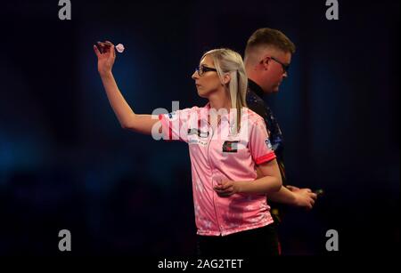 Fallon Sherrock and Ted Evetts in action during day five of the William Hill World Championships at Alexandra Palace, London. Stock Photo