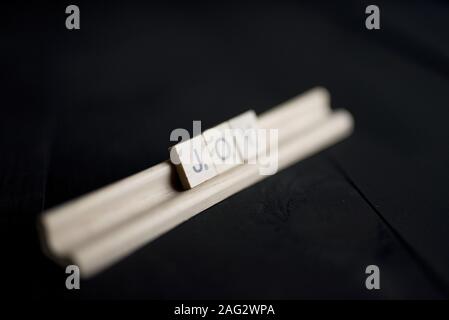 A closeup shot of wooden blocks spelling joy with a blurred background Stock Photo