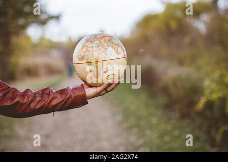 A closeup shot of a male holding a desk glove with a blurred background Stock Photo