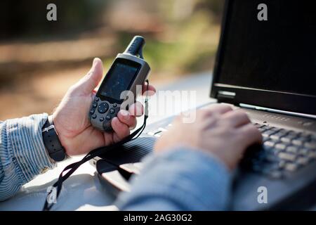 Man using G.P.S. and a laptop. Stock Photo