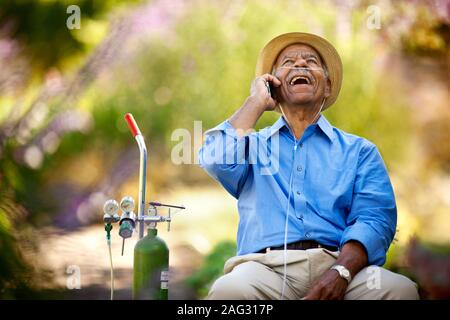 Senior man talking on his cellphone and laughing. Stock Photo