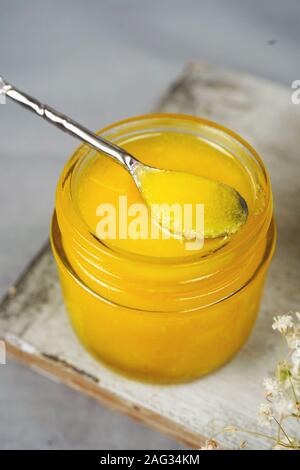 Homemade Ghee / Clarified butter in a glass jar, selective focus
