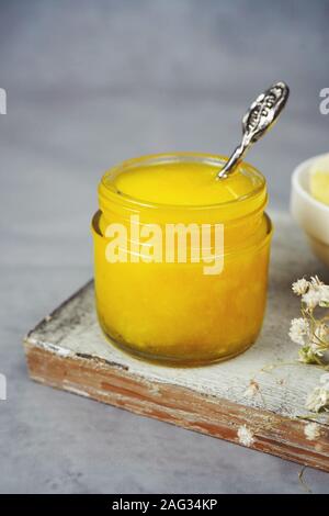 Homemade Ghee / Clarified butter in a glass jar, selective focus Stock Photo