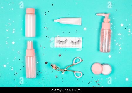 Care cosmetics on a trendy green background. Flat lay style. Stock Photo