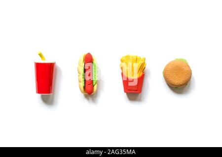 Varied miniature toy fast food in miniature with soft shadows isolated on a white background. Stock Photo