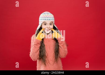 definition of cool. funny knitwear accessory. small happy girl in knitted hat. cheerful child in gloves wear warm clothes. have fun on winter holiday. christmas time. fashion for kids. Stock Photo