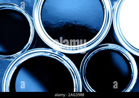 Several opened cans with blue paint inside. Close up. Top View Stock Photo