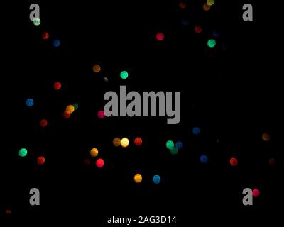Beautiful shot of assorted-color bokeh lights in the dark - great for a wallpaper Stock Photo