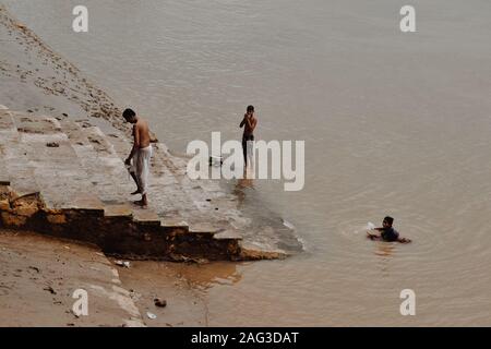 Mens chating and bathing in the Ganges River Stock Photo