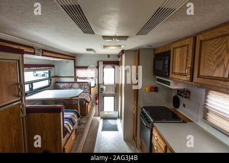 Interior of an Artic Fox truck camper showing the kitchen and dinette. Stock Photo