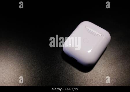 Closeup shot of a white air pod's charging case on a black background Stock Photo