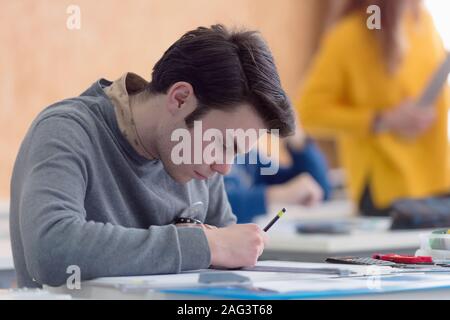 Male university architecture student working on practice lessons. Looking for solution during class. Stock Photo