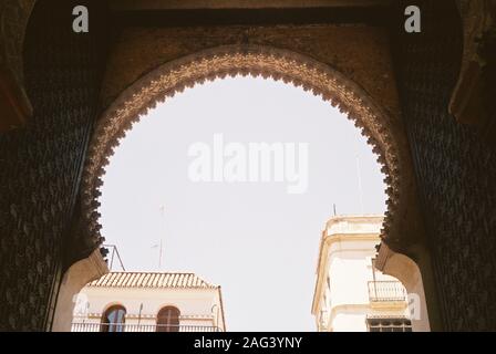 Low angle shot of a concrete arch with beautiful patters under the clear blue sky Stock Photo