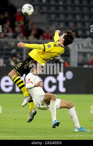 Dortmund, Germany. 17th Dec, 2019. Mats Hummels (Top) of Dortmund vies with Yussuf Poulsen of Leipzig during a German Bundesliga match in Dortmund, Germany, Dec. 17, 2019. Credit: Joachim Bywaletz/Xinhua/Alamy Live News Stock Photo