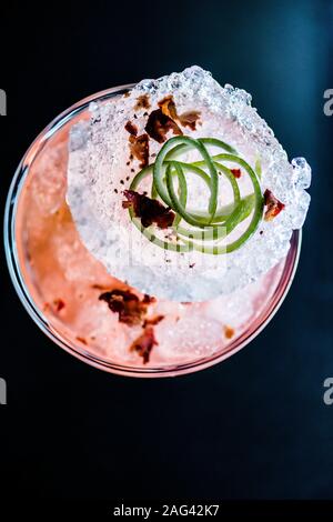 Vertical high angle shot of molecular cuisine dish in a glass with a big piece of ice Stock Photo