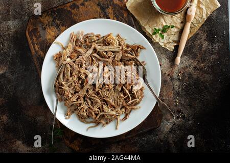 Pulled pork with forks on a plate Stock Photo