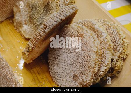 Honey in honeycomb from round beehive with sweet honey Stock Photo