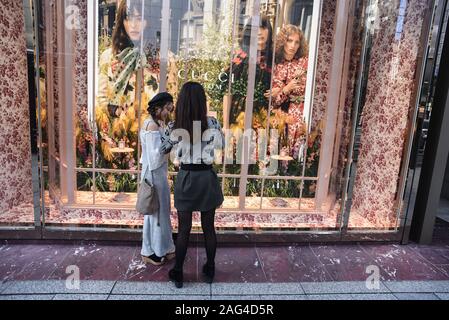 Two girls in front of Gucci store in Ginza, Tokyo, Japan Stock Photo