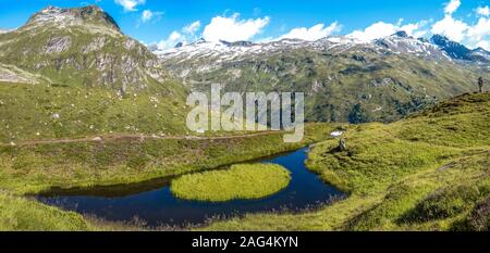 Beautiful panorama of a lake in the middle of mountainous scenery in Grossvenediger, Austria Stock Photo
