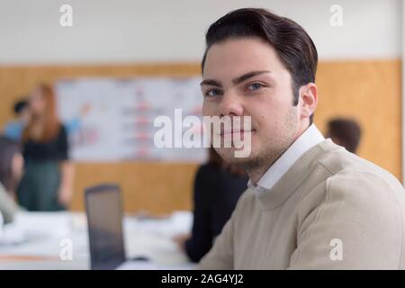 Male university architecture student working on practice lessons. Looking for solution during class. Beautiful positiv male student smiling at camera. Stock Photo