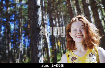 Redhead woman having fun in the wild forest Stock Photo