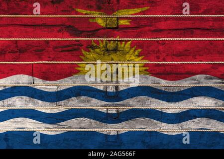 National flag  of Kiribati on a wooden wall background. The concept of national pride and a symbol of the country. Flags painted on a wooden fence wit Stock Photo