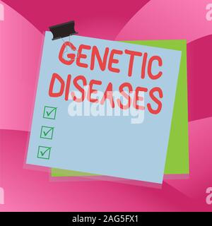 Handwriting text writing Genetic Diseases. Conceptual photo disease caused by an abnormality in an individual s is genome Paper stuck binder clip colo Stock Photo
