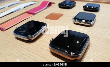 BANGKOK, THAILAND - DECEMBER 13, 2019: The part of Apple watch such as strap, screen are showing in the wooden table in the Apple Store Iconsiam. Stock Photo