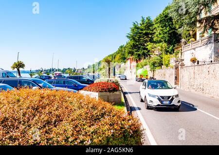 Toscolano Maderno, Lombardy, Italy - September 12, 2019: Scenic panoramic beltway road around lake Garda with medieval architecture buildings and rich Stock Photo