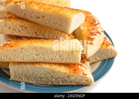 Cheese bread. Homemade delicious  soft cheese bread sticks close up on a plate on white background Stock Photo