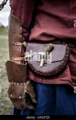 Vertical closeup shot of a Viking warrior with leather gloves and bum bag Stock Photo