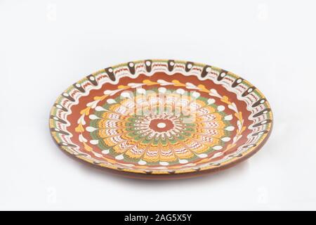 High angle shot of a ceramic plate with beautiful patterns isolated on a white background Stock Photo