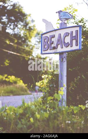 Holiday background, Beach road sign Stock Photo - Alamy
