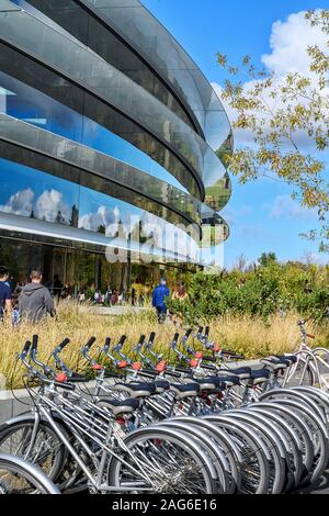 Cupertino CA USA December 14, 2019: Closeup of Apple headquarters offices building exterior and Apple bicycles that employees can use to travel around Stock Photo