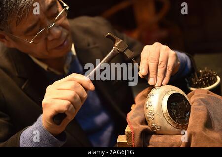 191218 -- BEIJING, Dec. 18, 2019 -- Dong Ruijing engraves Chinese ...