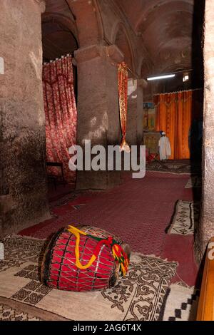 Ethiopia, Amhara, Lalibela, ancient rock cut churches, inside Bet Medhane Alem church, ritual drums used in mass Stock Photo