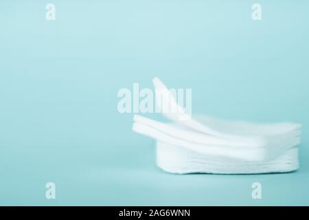 Cosmetology, cleanliness and branding concept - Organic cotton pads on mint background, cosmetics and make-up remover, hygiene and skincare beauty bra Stock Photo