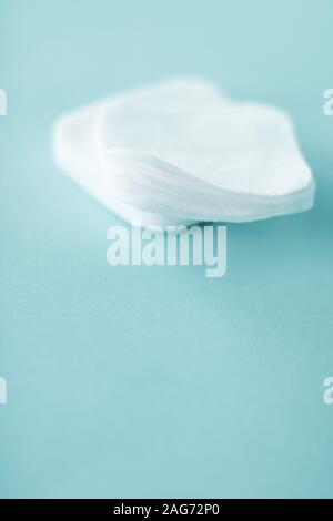 Cosmetology, cleanliness and branding concept - Organic cotton pads on mint background, cosmetics and make-up remover, hygiene and skincare beauty bra Stock Photo