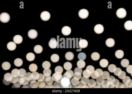 White Blurred Lights on Black Background in Center Frame Stock Photo