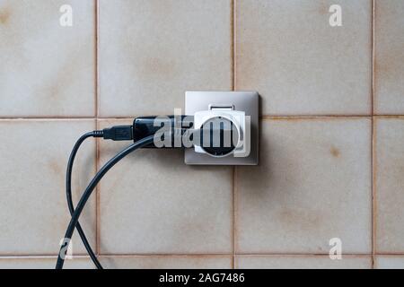 a socket on a tiled wall Stock Photo