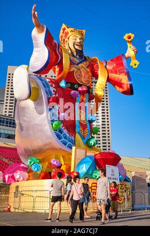 An exuberant figure of the Taoist God of Wealth or Good Fortune, set up on occasion of the Chinese New Year, by the Esplanade at Marina Bay, Singapore Stock Photo