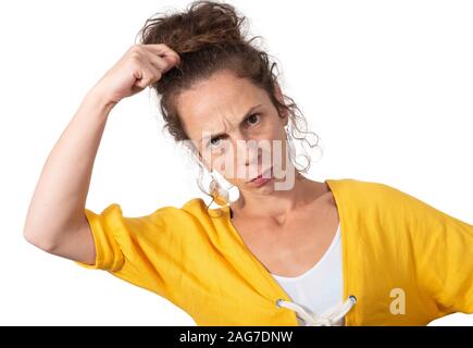 Confused beautiful girl scratches head, isolated on white background Stock Photo