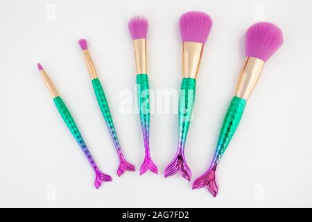 Make up brushes in mermaid theme cosmatic makeup brushes on a white background. Stock Photo