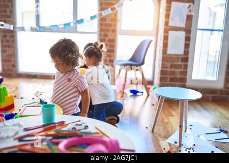 Young beautiful teacher and toddlers playing at kindergarten Stock Photo