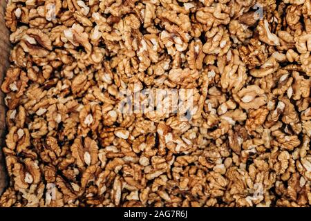 Closeup of big shelled walnuts pile. The background of their shelled walnuts. Stock Photo