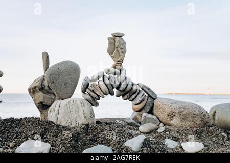 Figures of stones on the beach near the sea. Sea background and stone figures. Stock Photo