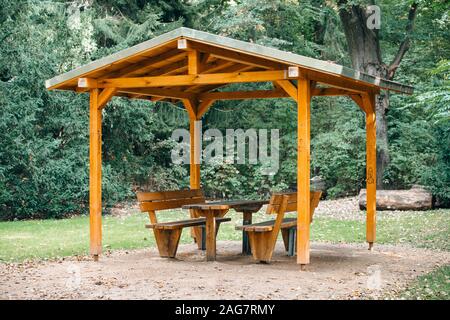 Covered seating area. Gazebo, pergola in parks and gardens - relax and unwind. Wooden gazebo in the Park Stock Photo